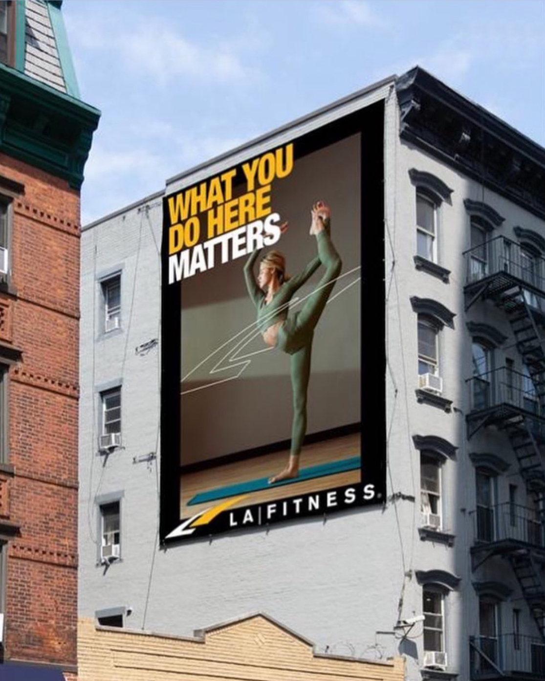 LA Fitness Billboard featuring an image by Caleb Kuhl of a caucasian woman practicing yoga