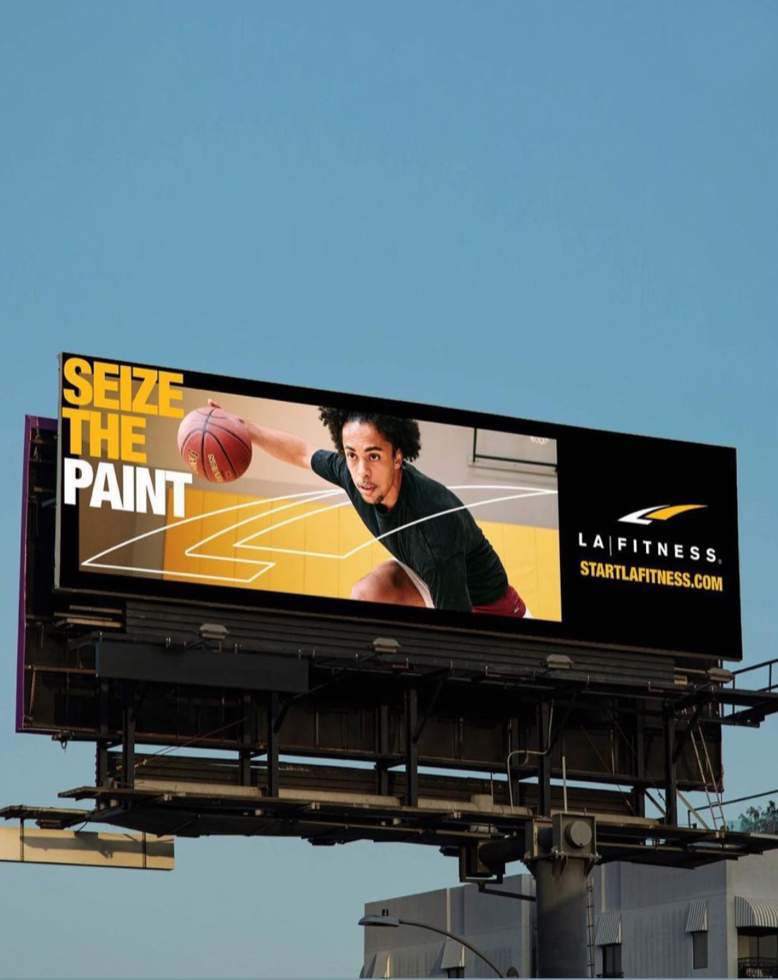 LA Fitness Billboard featuring an image by Caleb Kuhl of an african american man playing basketball in a gym